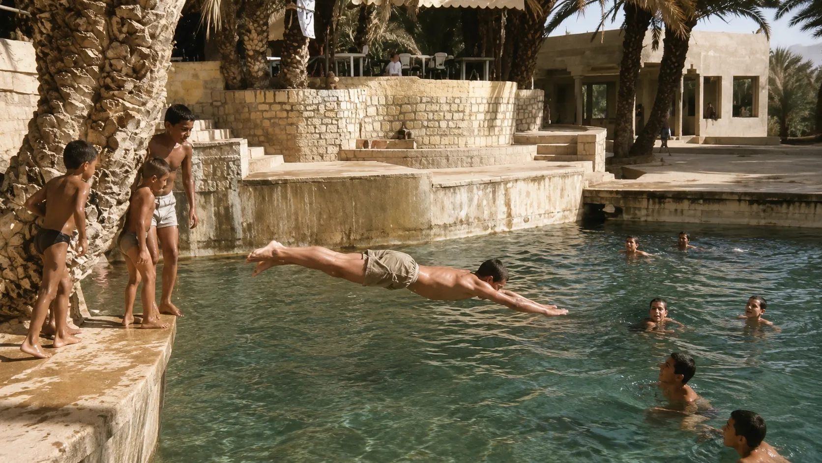 A boy diving into the Blue Spring as others watch