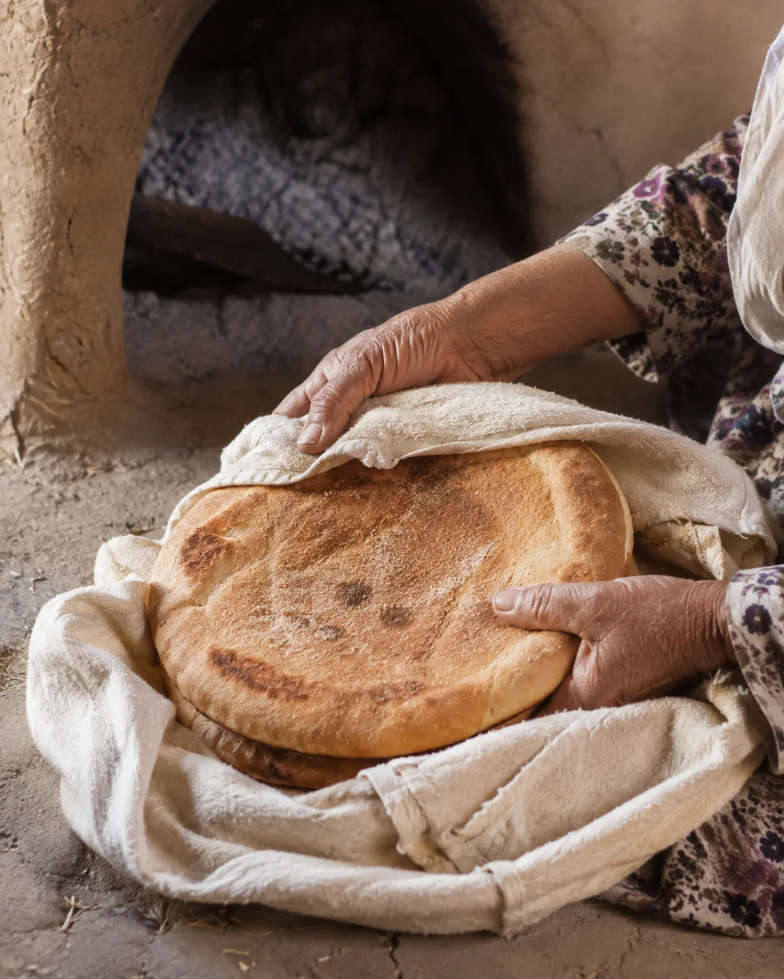 Hands handling freshly baked homemade bread in a modest family home