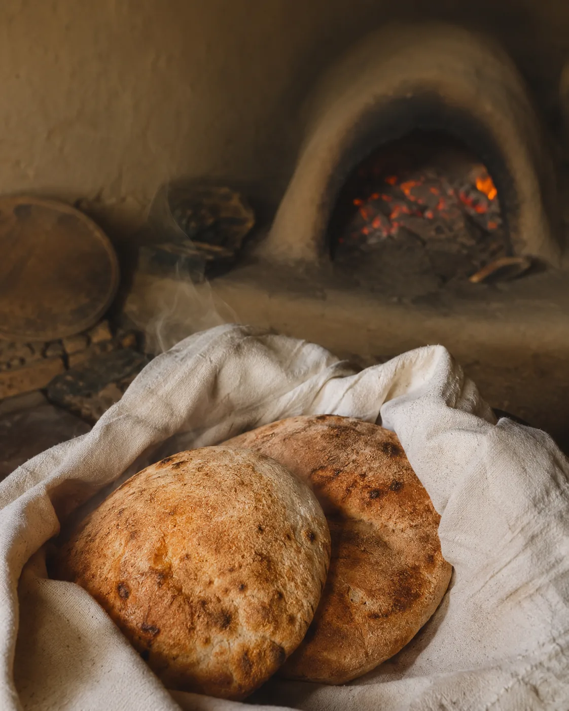 Fresh bread resting inside a simple family cloth