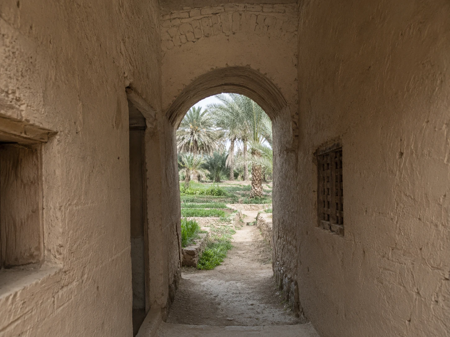 A quiet traditional passage opening toward the oasis of Meski