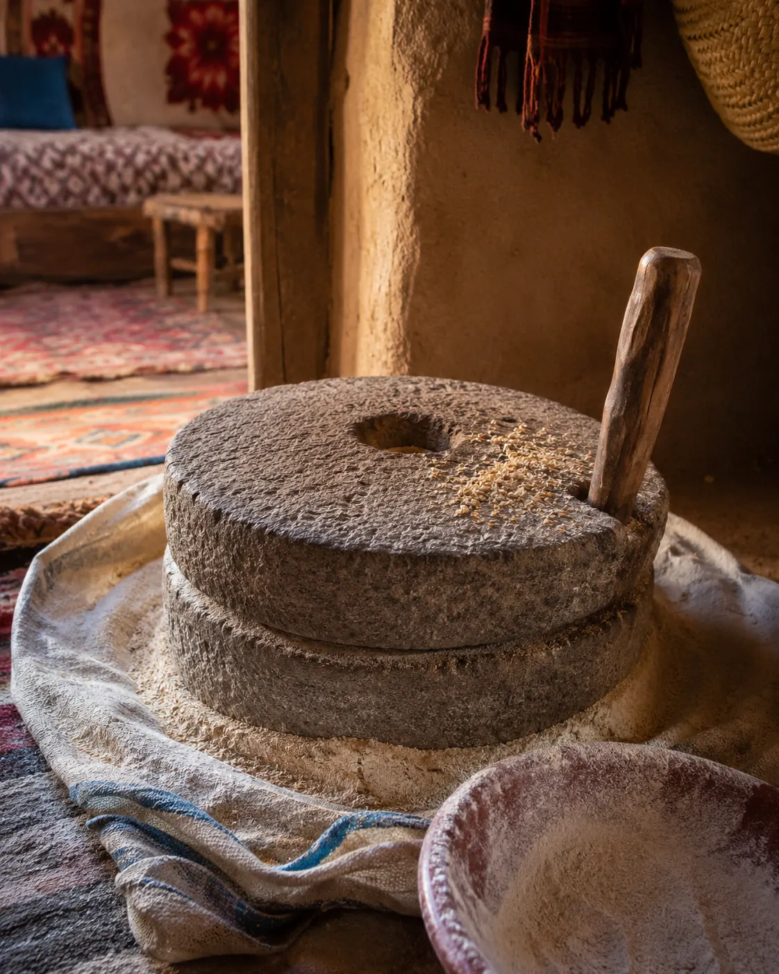 A traditional hand-operated stone mill used for grinding wheat