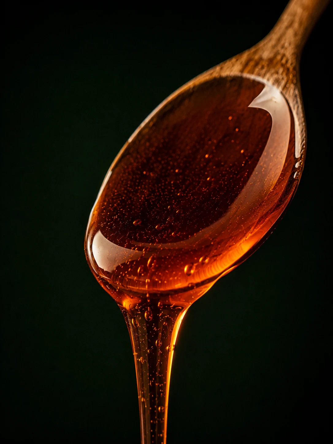 Deep amber Greek Sidr honey on a spoon