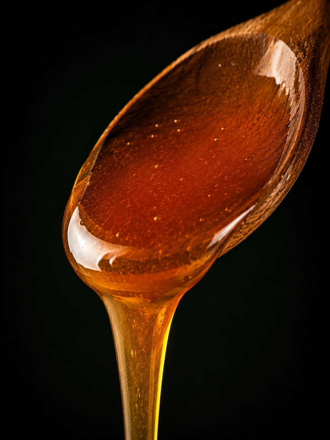 Deep amber Moroccan thyme honey on a spoon