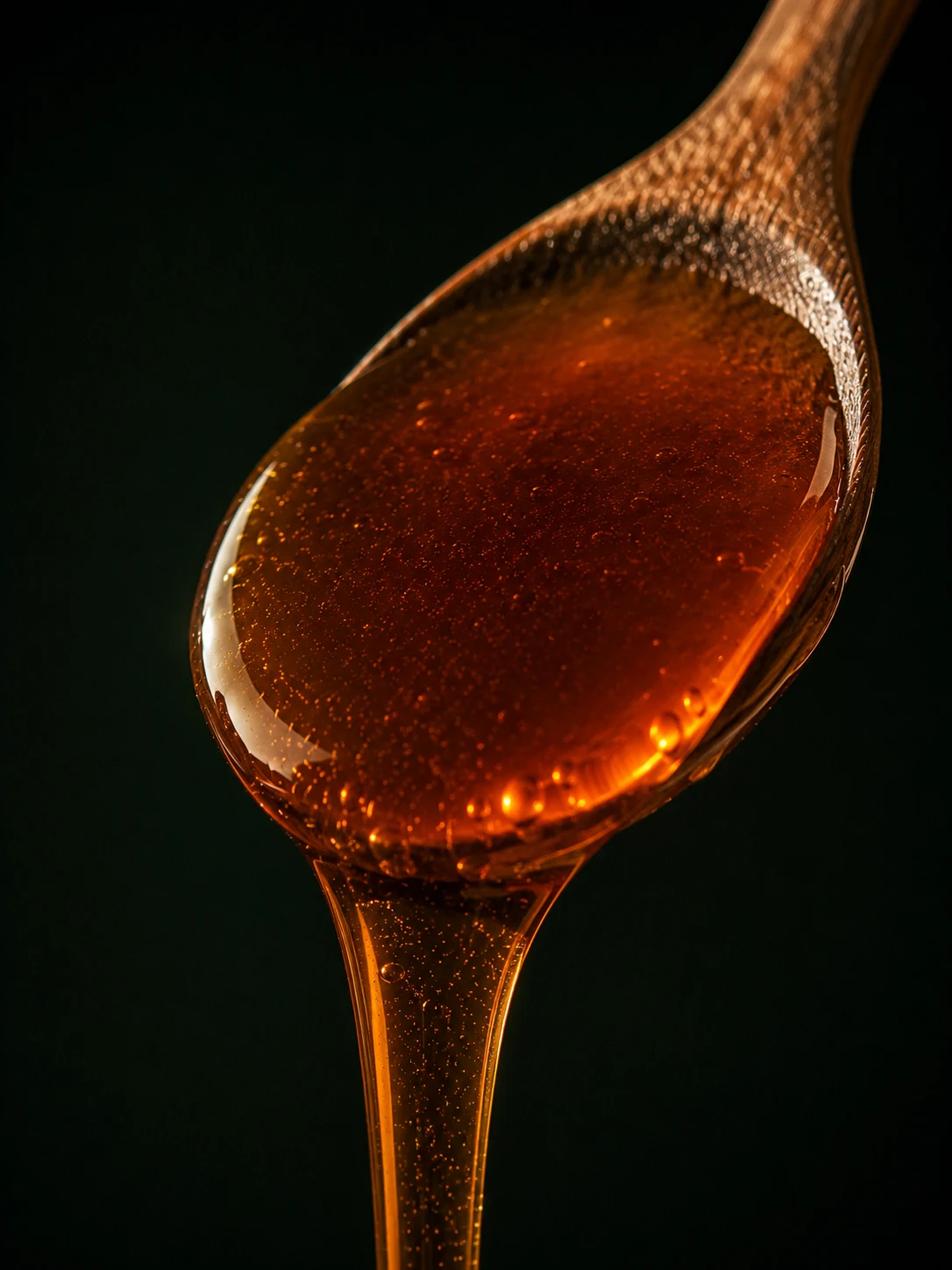 Thick amber Himalayan Sidr honey on a spoon