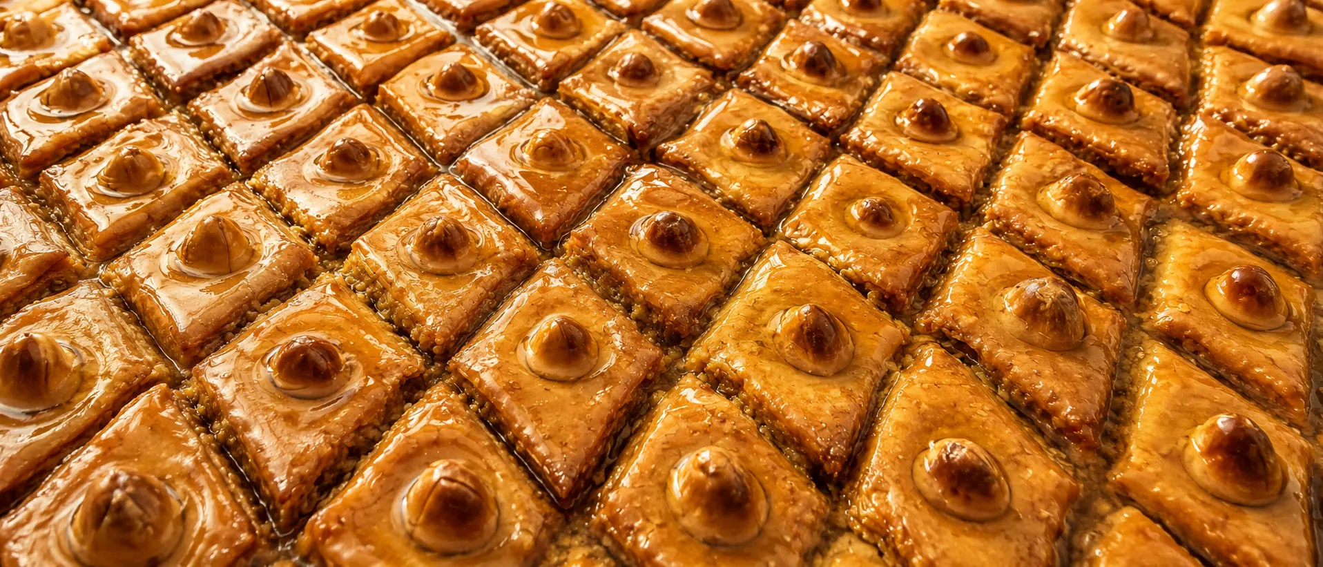 Homemade baklava prepared with my mother, glossy with honey and topped with nuts.