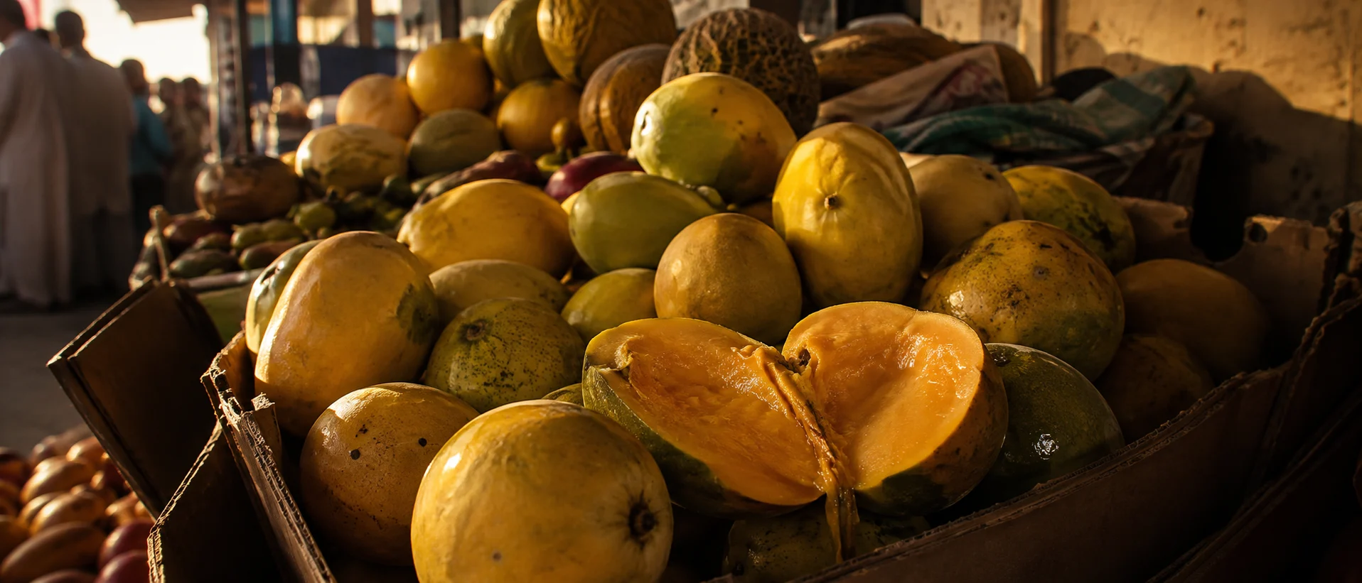Ripe Yemeni mangoes for sale in cardboard crates at an everyday produce market in the United Arab Emirates
